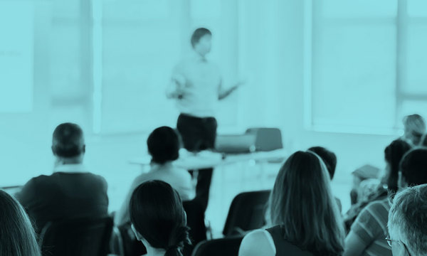 People in a seminar listening to a speaker
